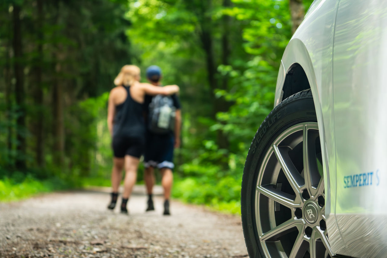 Couple-Forest-Walk in the Backround (tyre in foreground)
